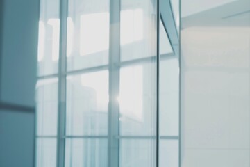 Blurred glass wall of modern business office building at the business center use for background in business concept. Blur corporate business office. Abstract windows with a blue tint