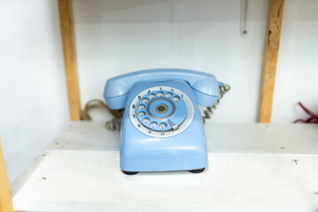 Old telephone on white background. Shallow depth of field.
