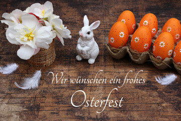 Grußkarte Frohe Ostern: Arrangement mit Osterhasen, Blumen und gefärbten Ostereiern.