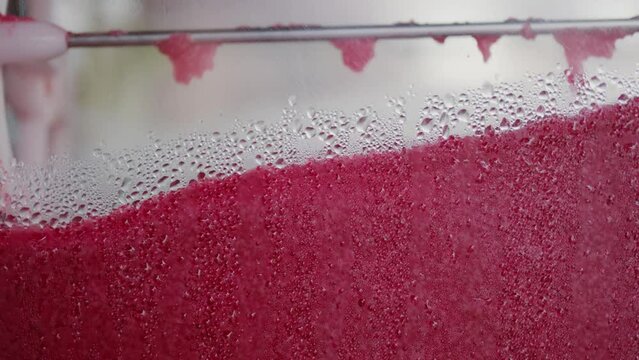 Slush ice machine mixing in slow motion providing your customers with delicious flavours