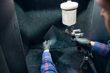 Employer selecting and mixing of colors for car painting