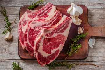 Close-Up 4K Ultra HD Image of Raw Ribeye Steak with Herbs - Stock Photography