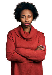 African american woman with afro hair with arms crossed gesture skeptic and nervous, frowning upset...