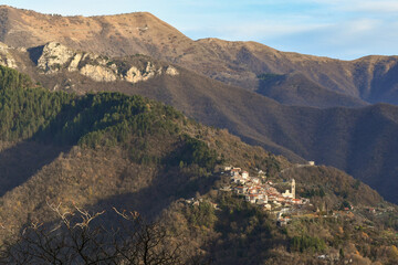 Elevated view of the Argentina Valley in the Ligurian hinterland with the ancient village of Andagna, in the municipality of Molini di Triora, in winter, Imperia, Liguria, Italy