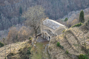Elevated view of the church of San Bernardino (15th century), a short distance from the so-called "village of witches", in winter, Triora, Imperia, Liguria, Italy