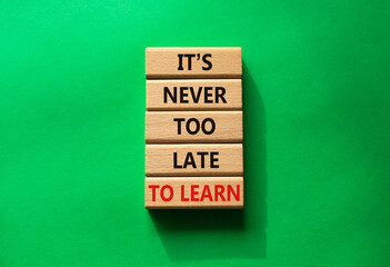 It is Never to Late to Learn symbol. Wooden blocks with words It is Never to Late to Learn. Beautiful green background. Business and It is Never to Late to Learn. Copy space.