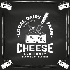 Local dairy farm badge design on the chalkboard. Template for logo, branding design with block cheese, fork for cheese and bee. Vector illustration. Cheese and honey family farm. - 765927730