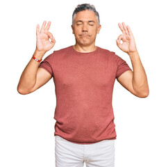 Handsome middle age man wearing casual clothes relax and smiling with eyes closed doing meditation gesture with fingers. yoga concept.