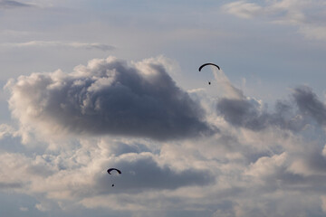 photo taken as paratroopers depart with dense clouds in the background