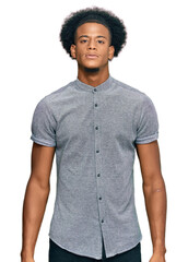 African american man with afro hair wearing casual clothes relaxed with serious expression on face....