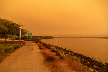 California Westpoint Slough on San Francisco Bay, California; Orange Smoke Filled Skies from Nearby Out of Control Wildfires Caused by Drought and Climate Change - 765935353