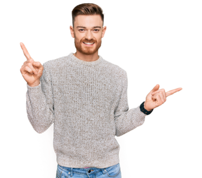 Young redhead man wearing casual winter sweater smiling confident pointing with fingers to different directions. copy space for advertisement