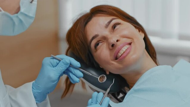 Smiling Woman in Dentist Chair: Close-up Interaction with Dentist