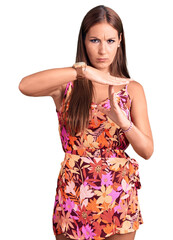 Young beautiful hispanic woman wearing casual clothes doing time out gesture with hands, frustrated...