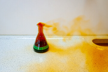Chemical experiment in which Nitric acid (HNO3) is placed in an Erlenmeyer flask with copper chips,...