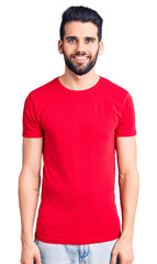 Young handsome man with beard wearing casual t-shirt with a happy and cool smile on face. lucky person.
