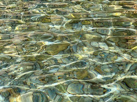 Stones, pebbles  in transparent sea water.