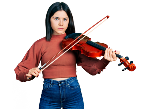 Young brunette woman with blue eyes playing violin relaxed with serious expression on face. simple and natural looking at the camera.
