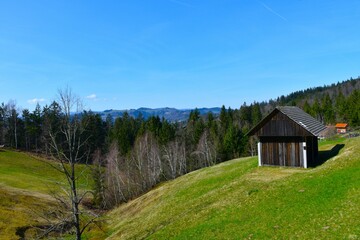 Fototapeta na wymiar Barn on a meadow at Žirovski vrh in Slovenia