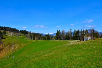 View of a meadow with a bunker at the Rupnik defensive line at Žirovski vrh and Triglav mountain in Gorenjska, Slovenia