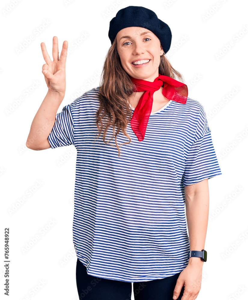 Poster young beautiful blonde woman wearing french beret and striped t-shirt showing and pointing up with f