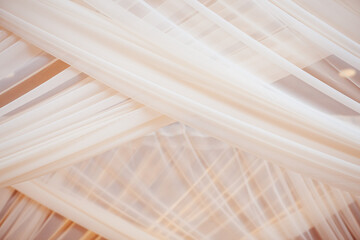 close up of sheer tulle cloth with draping texture on wedding huppah