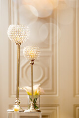 Detail of ceremony decor with white calla lily arrangement in glass vase