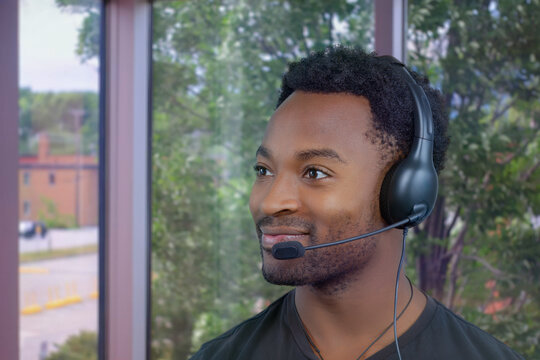 contact us support center customer service man smiling helpline african office receptionist headset