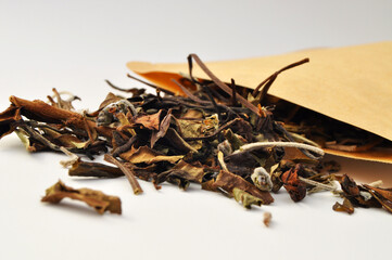 Handcrafted lavender and lemon balm tea leaves coming out of the packet that contains it