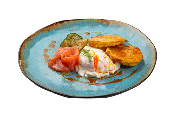 poached egg with salmon, cucumbers and pancakes on an isolated white background in a plate