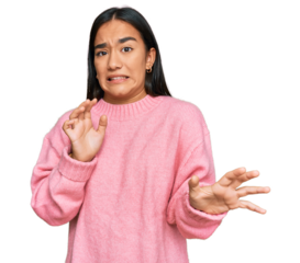 Young asian woman wearing casual winter sweater disgusted expression, displeased and fearful doing disgust face because aversion reaction.