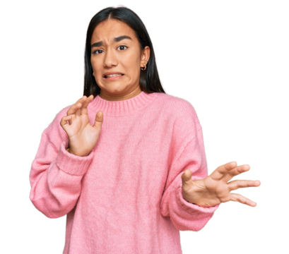 Young asian woman wearing casual winter sweater disgusted expression, displeased and fearful doing disgust face because aversion reaction.