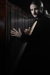 Harp player. Irish harpist playing celtic music. Classical musician - 765956976