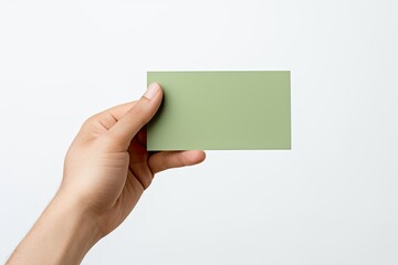 Fototapeta premium Hand holding a blank green business card on white background