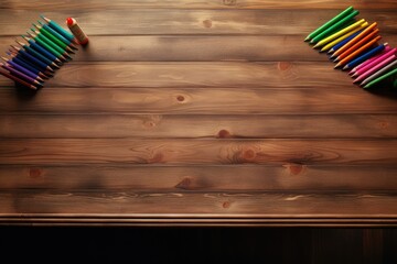 Colored pencils ordered on wooden background