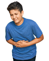 Teenager hispanic boy wearing casual clothes with hand on stomach because indigestion, painful...
