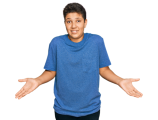 Teenager hispanic boy wearing casual clothes clueless and confused expression with arms and hands raised. doubt concept.