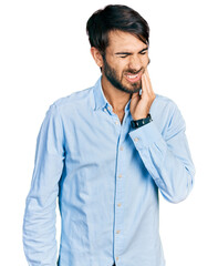 Hispanic man with blue eyes wearing business shirt touching mouth with hand with painful expression because of toothache or dental illness on teeth. dentist