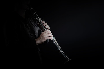Clarinet player. Clarinetist hands playing woodwind music instrument - 765961782