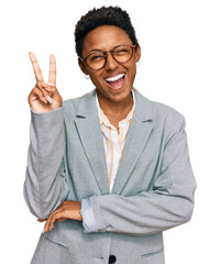 Young african american woman wearing business clothes smiling with happy face winking at the camera doing victory sign with fingers. number two. - obrazy, fototapety, plakaty