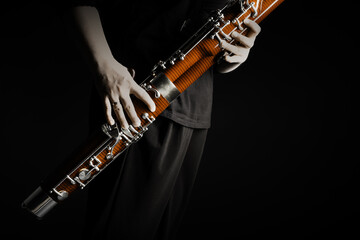 Bassoon woodwind instrument with player hands. Classical orchestral bass