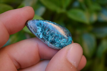 Chrysocolla mineral gem on the garden