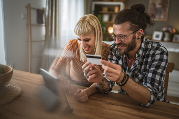 adult happy couple man and woman shopping online hold credit card