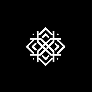 A large round snowflake of white color on a black background. Snowflake made of felt fabric on a soft textile background.