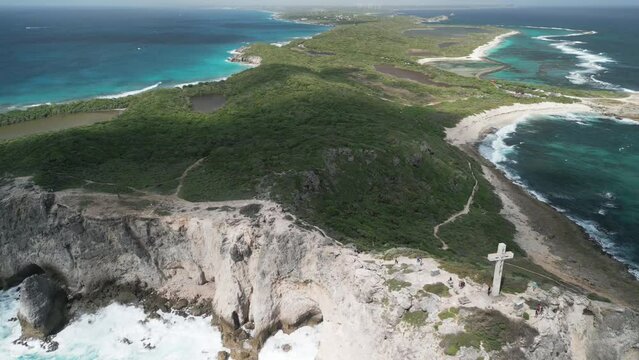 Aerial video of a cross looking out to sea, Pointe de Chateau, Guadeloupe,