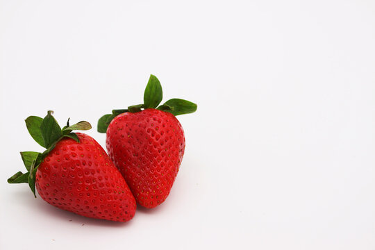 Image of red strawberries on a light background.
