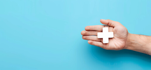 Hand holding medical plus icon with blue background