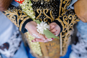 hand holding a jasmine ornament