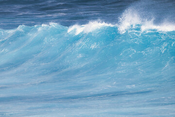 Beautiful aquamarine wave at the peak of breaking to shore.
