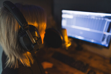 a woman radio presenter working at the studio, back view . High quality photo
